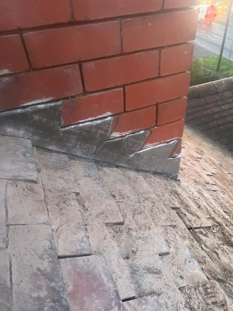 This is a photo of new leadwork being installed around an old chimney. Works carried out by Tipton Roofing Repairs